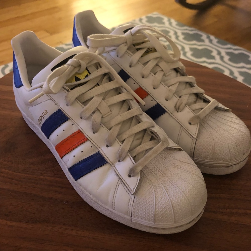 Men’s Adidas Superstars with navy/orange stripes